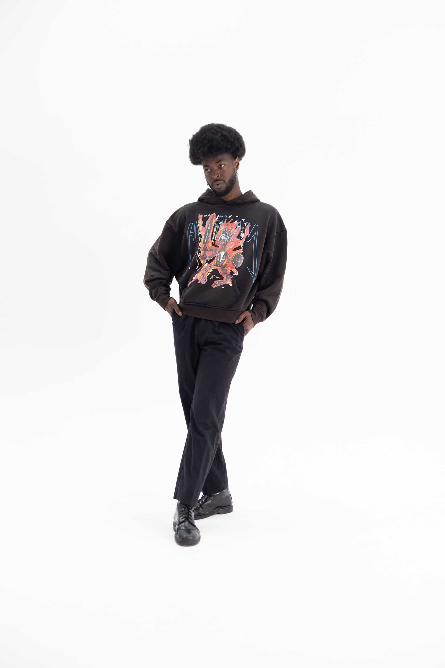Person wearing a sustainable black hoodie with a graphic design on a white background