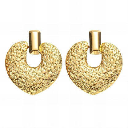 Pair of gold earrings with textured design on a white background