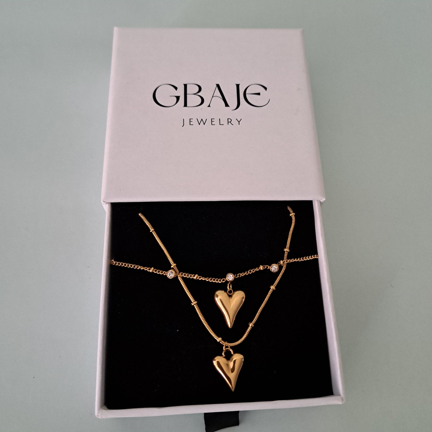 gold heart necklace in gbaje's branded box
