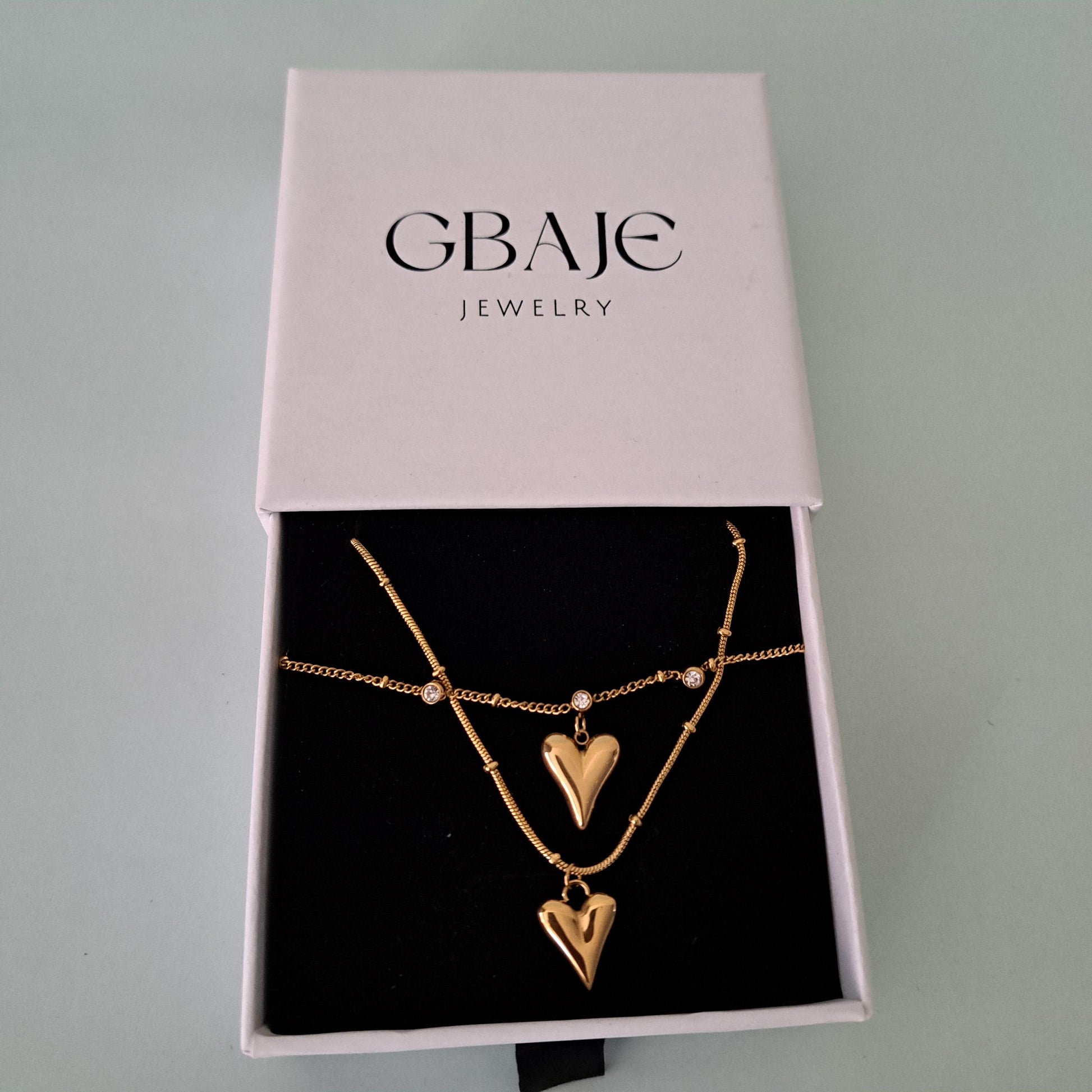 gold heart necklace in gbaje's branded box