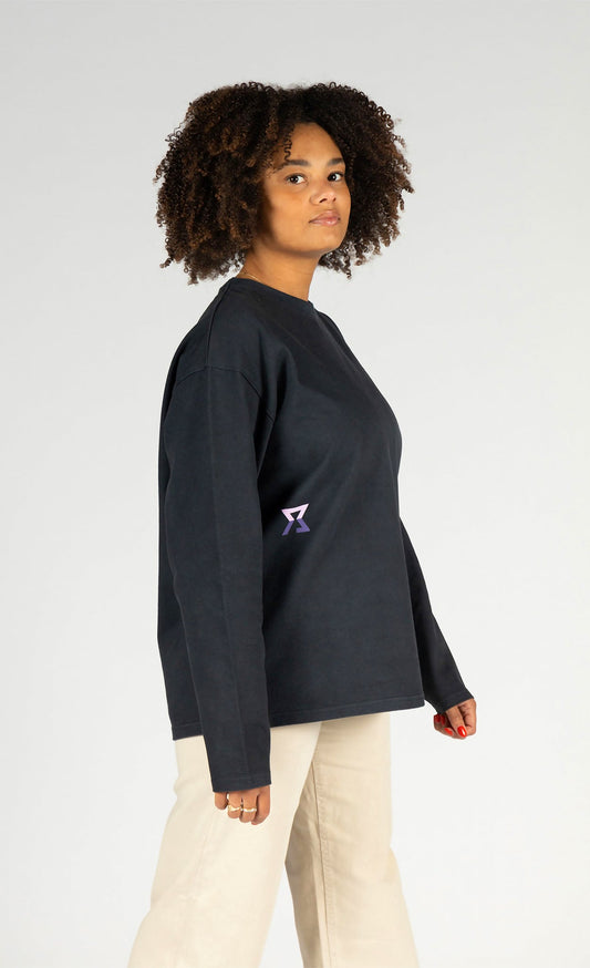 Female model wearing a blue long-sleeve polo shirt with a small logo on a white background
