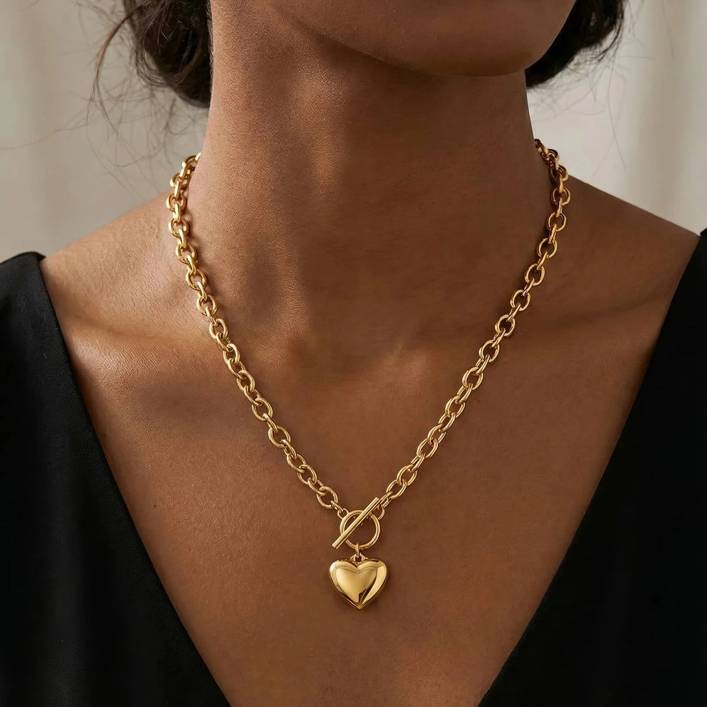 Thick cable chain with a heart pendant worn on a  woman's neck