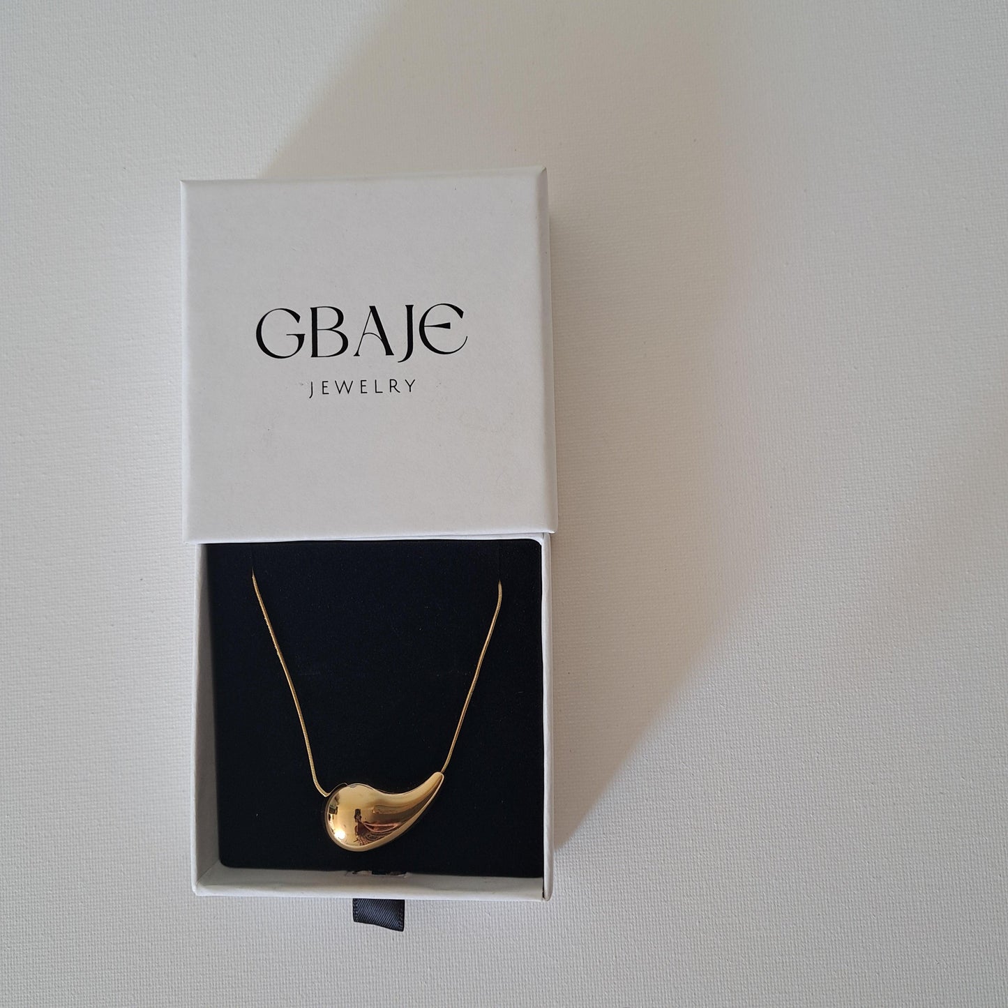 gold pendant necklace in gbaje jewelry branded box