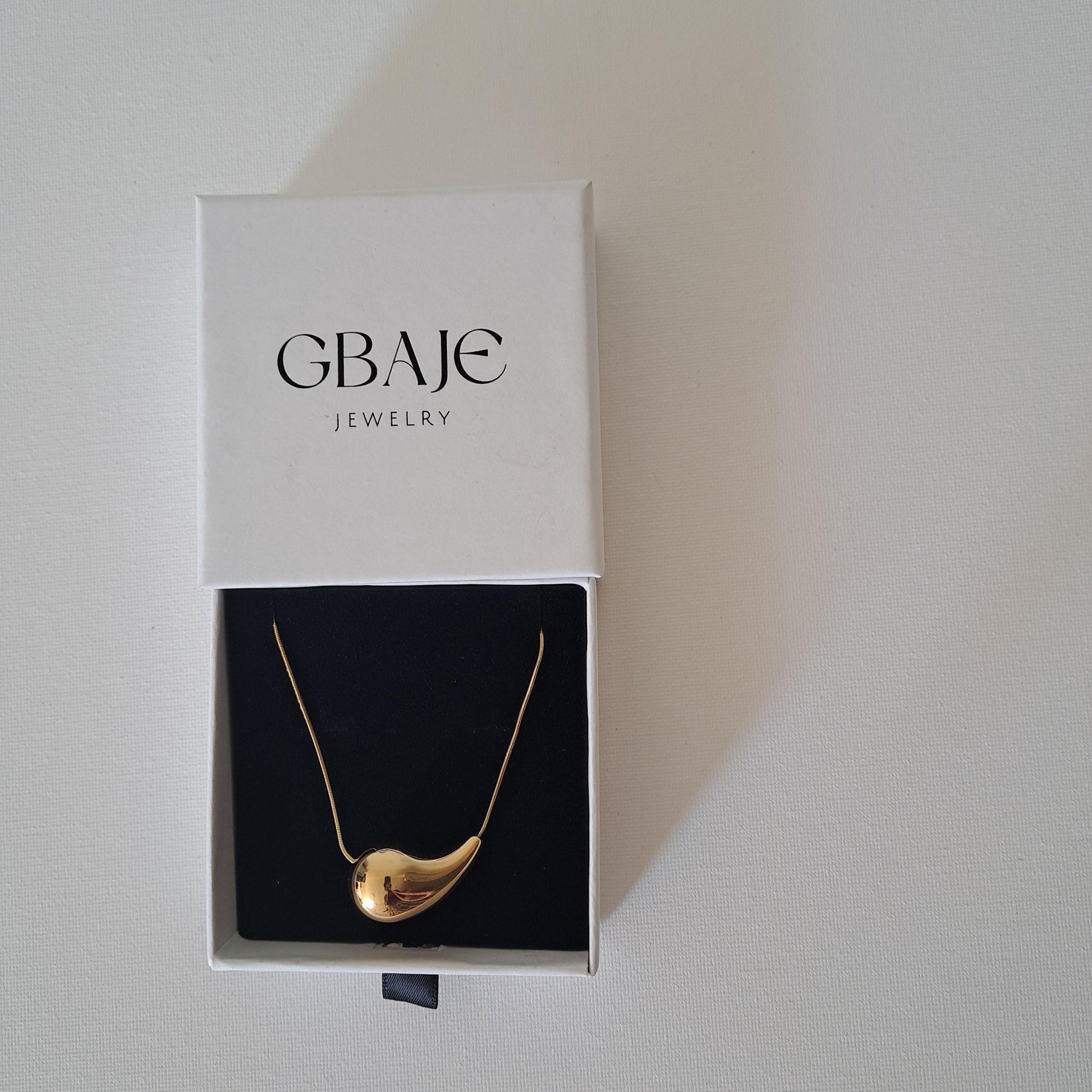 gold pendant necklace in gbaje jewelry branded box
