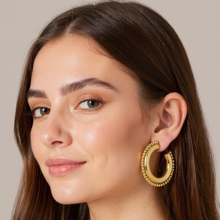 Hoop Gold earrings on a female model wearing black camisole