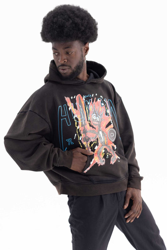 Person wearing a dark hoodie with a colorful graphic design on a white background made with recyled cotton
