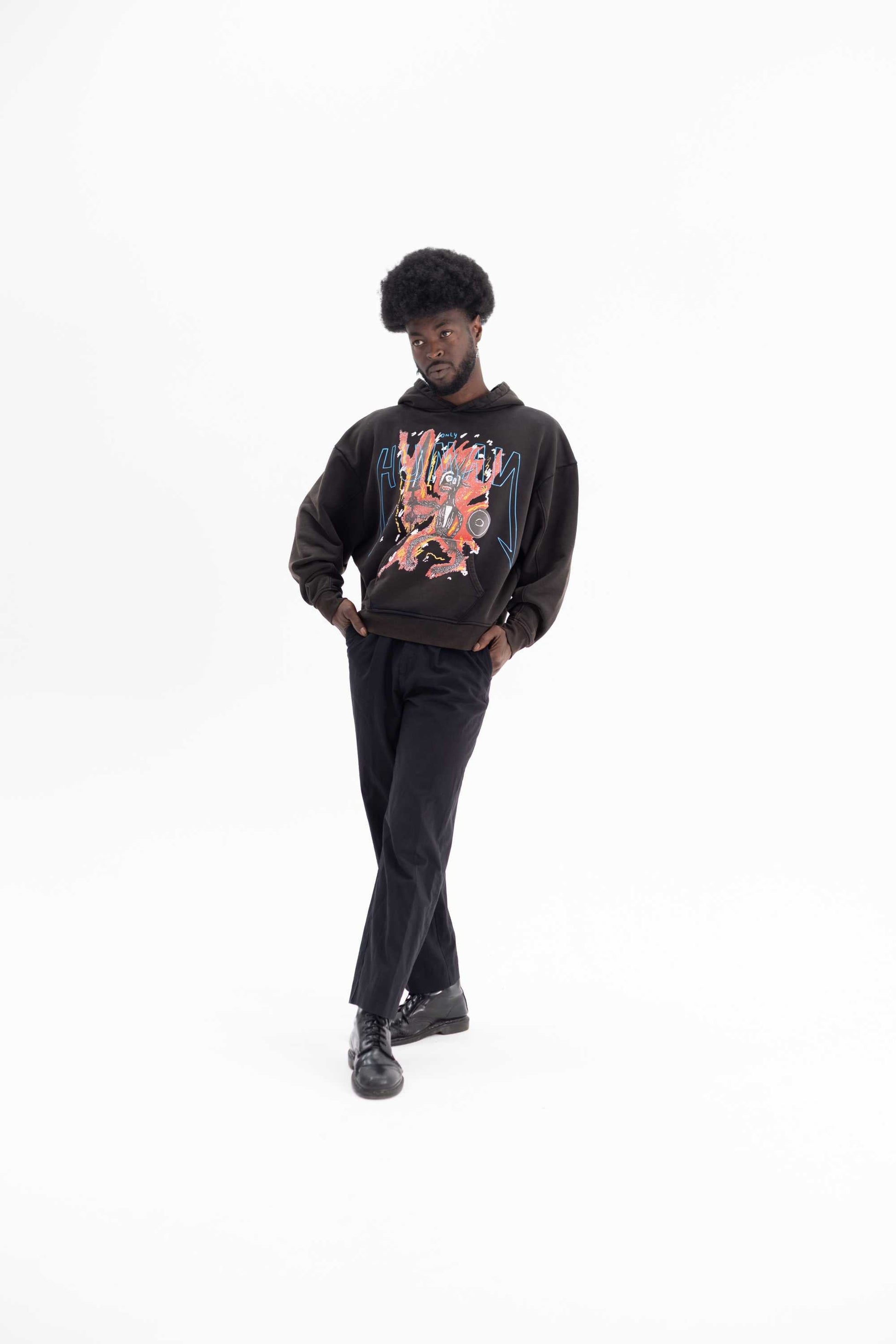Person wearing a sustainable black hoodie with a graphic design on a white background