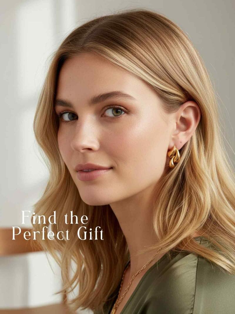 Woman wearing gold earrings with text 'Find the Perfect Gift' on a blurred background