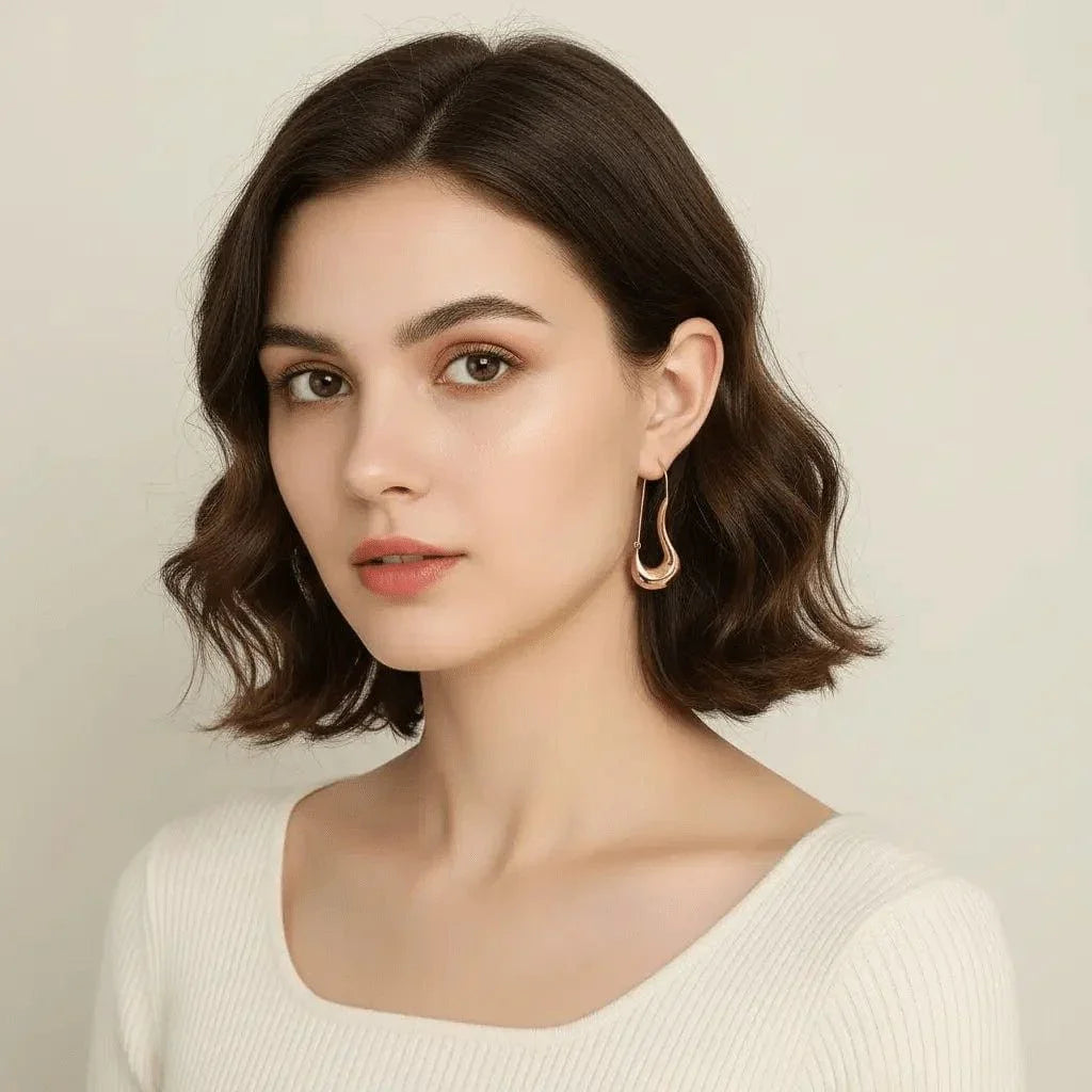 safety pin earrings worn by a model