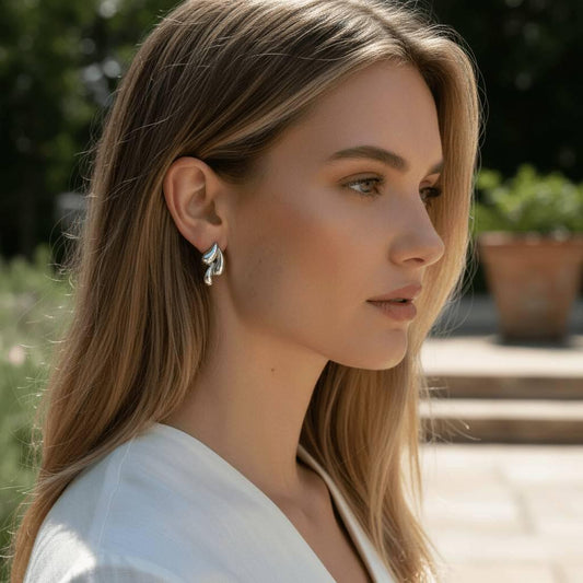 model wearing silver earrings